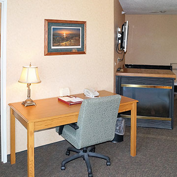 Are there any facilities for business travelers in the rooms?